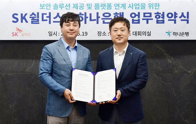 이동현 하나은행 기업사업본부장(사진 오른쪽)과 김윤호 SK쉴더스 성장추진실장(사진 왼쪽)이 기념촬영을 하고 있다. 사진/하나은행